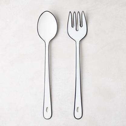 Diane Keaton + Hudson Grace white enamel serving spoon and fork with black borders.