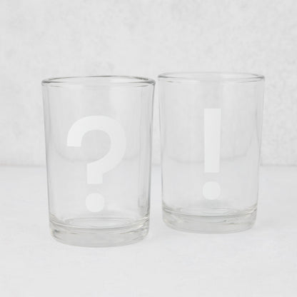 Two clear glass tumblers, one with a white question mark, one with a white exclamation point.