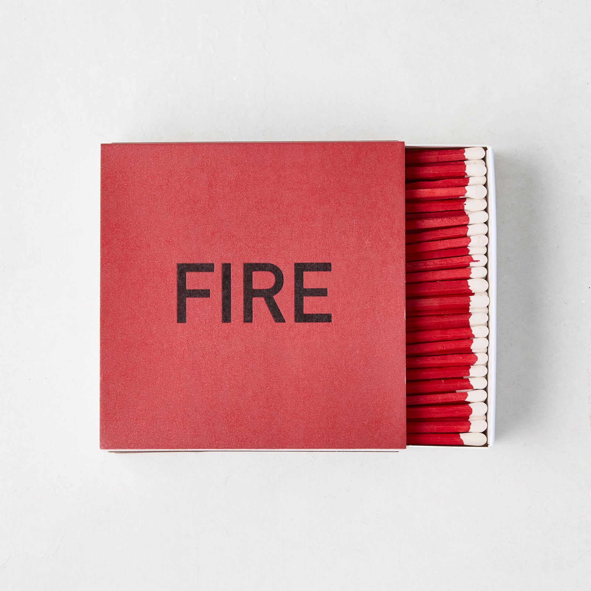 Diane Keaton x Hudson Grace "Fire" oversized boxed matches, red box with "FIRE" in black, red 4-inch matches visible.