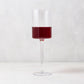 Diane Keaton + Hudson Grace High Rise Large Wine Glass, clear lead-free glass with red wine, modern straight-sided design.