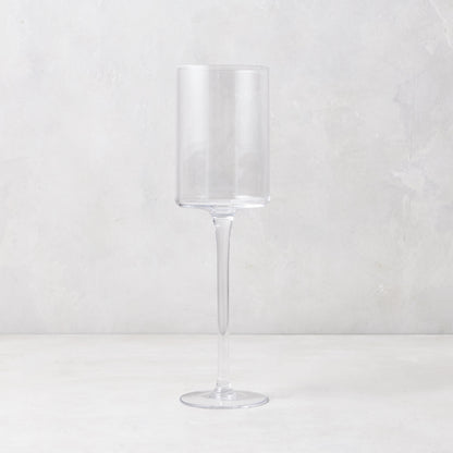 Clear, tall, straight-sided Diane Keaton + Hudson Grace High Rise Small Wine Glass on a white surface.