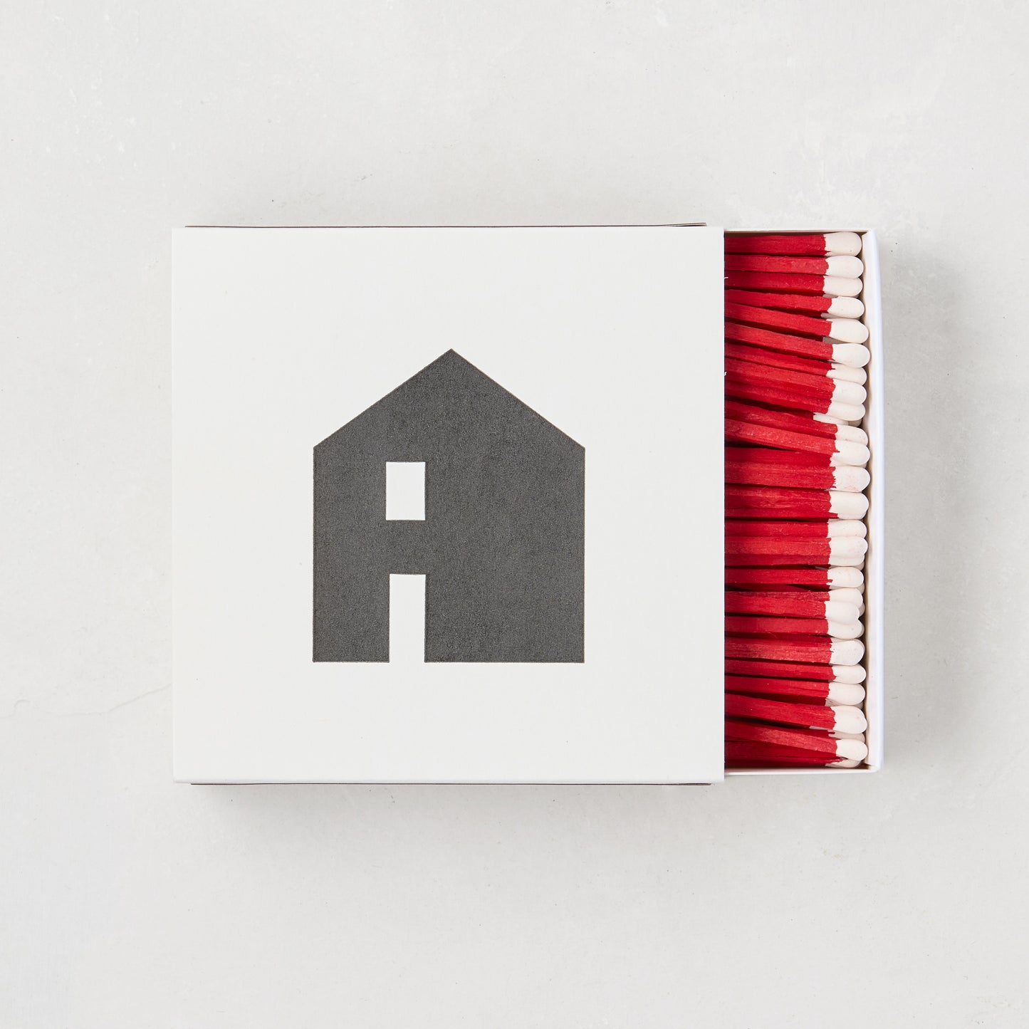 Diane Keaton + Hudson Grace "House Icon" white box with black house graphic, red-tipped matches.