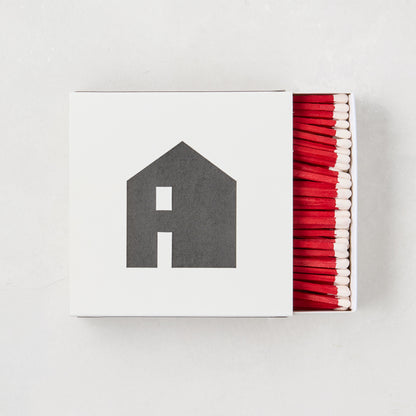 Diane Keaton + Hudson Grace "House Icon" white box with black house graphic, red-tipped matches.