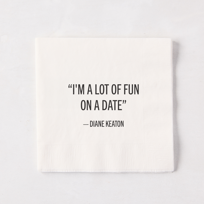 White 5.5" square paper cocktail napkin with "I'M A LOT OF FUN ON A DATE" - DIANE KEATON quote.