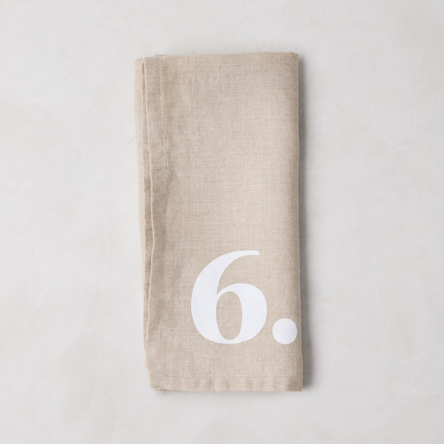 Diane Keaton + Hudson Grace Khaki Linen Numeric Napkin with a white number 6.