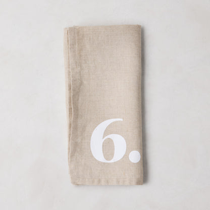 Diane Keaton + Hudson Grace Khaki Linen Numeric Napkin with a white number 6.