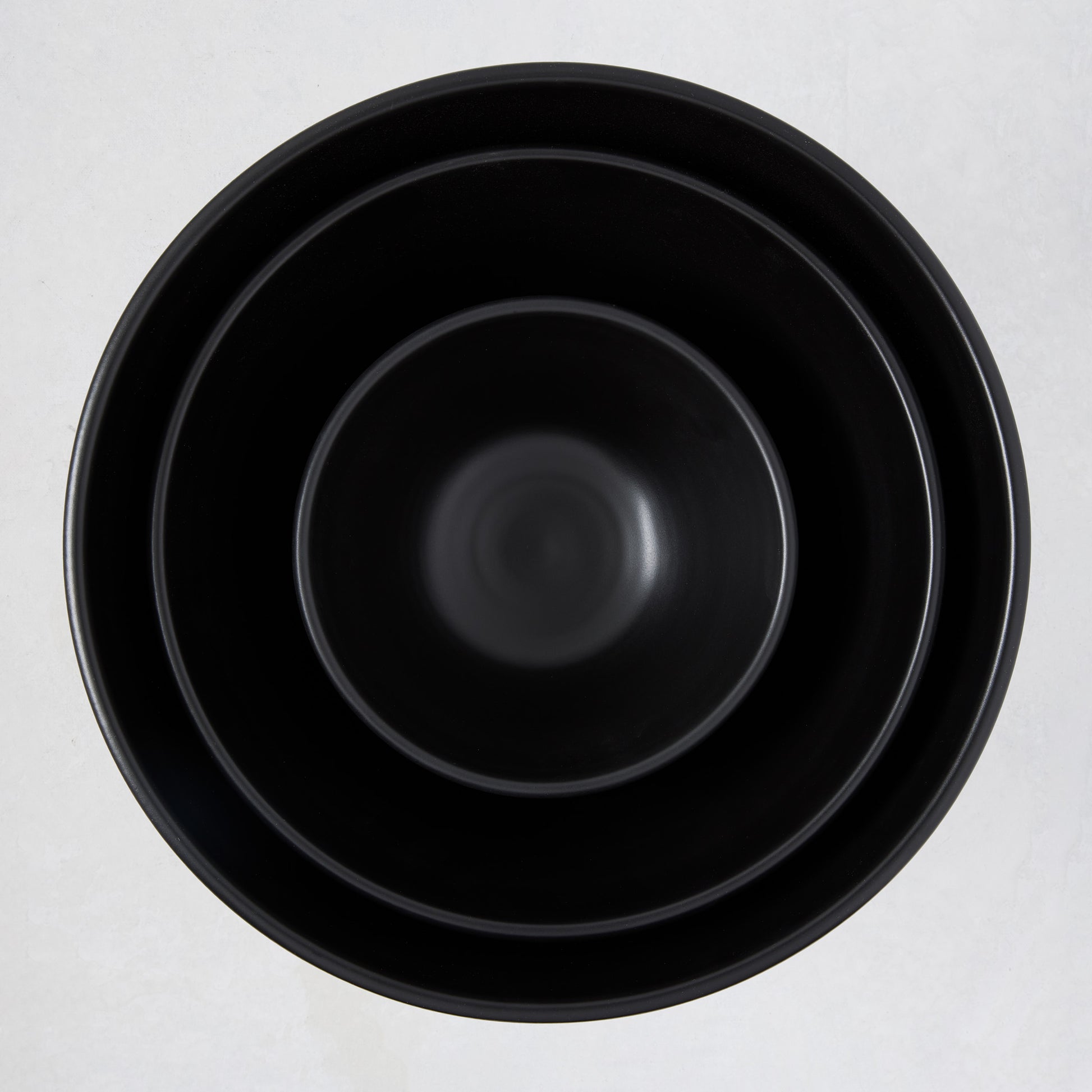 Diane Keaton + Hudson Grace matte black modern serve bowls, three sizes nested.