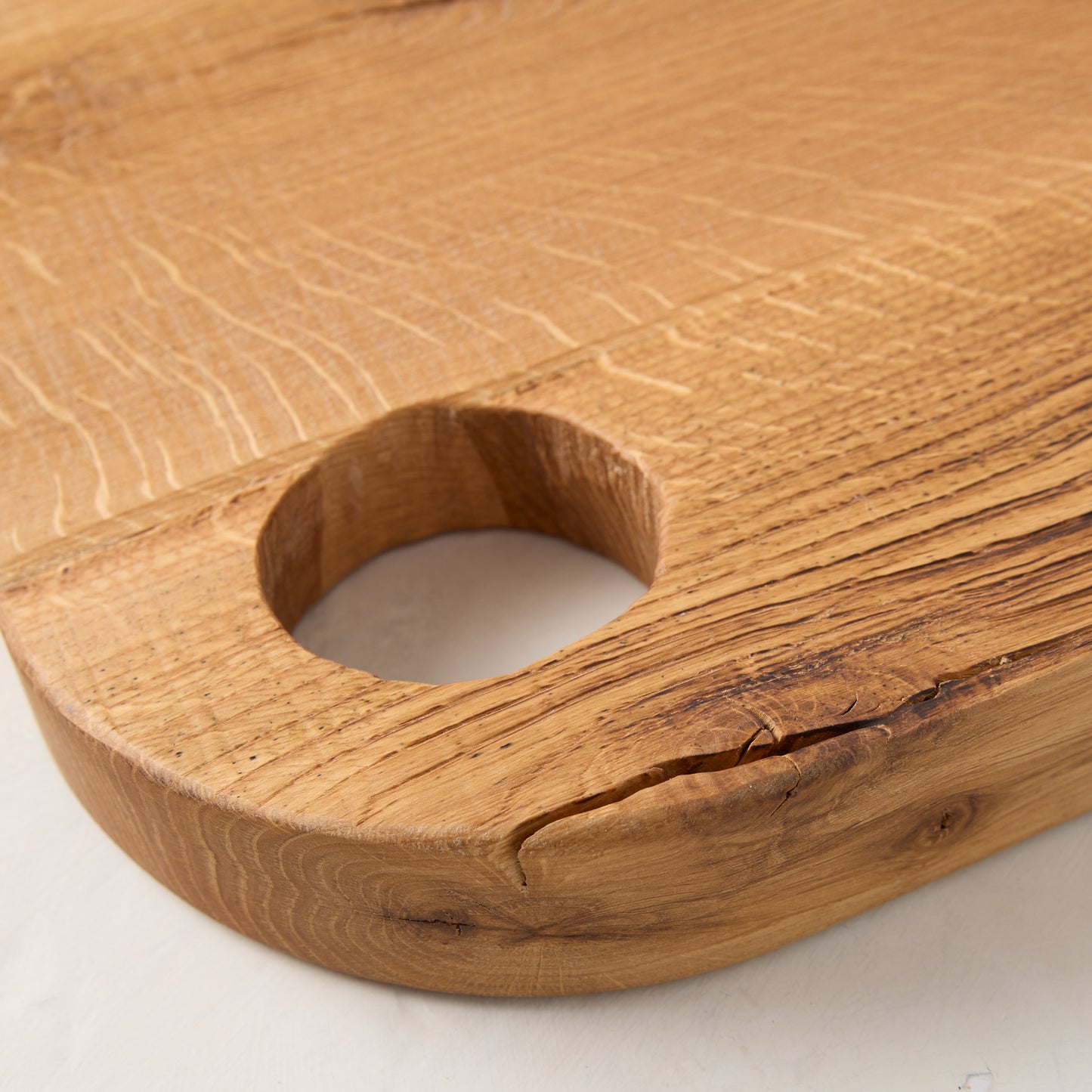 Large Diane Keaton + Hudson Grace reclaimed oak barnwood serving board with circular cutout handle.