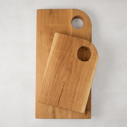 Large and small Diane Keaton + Hudson Grace reclaimed oak barnwood serving boards with circular cutout handles.