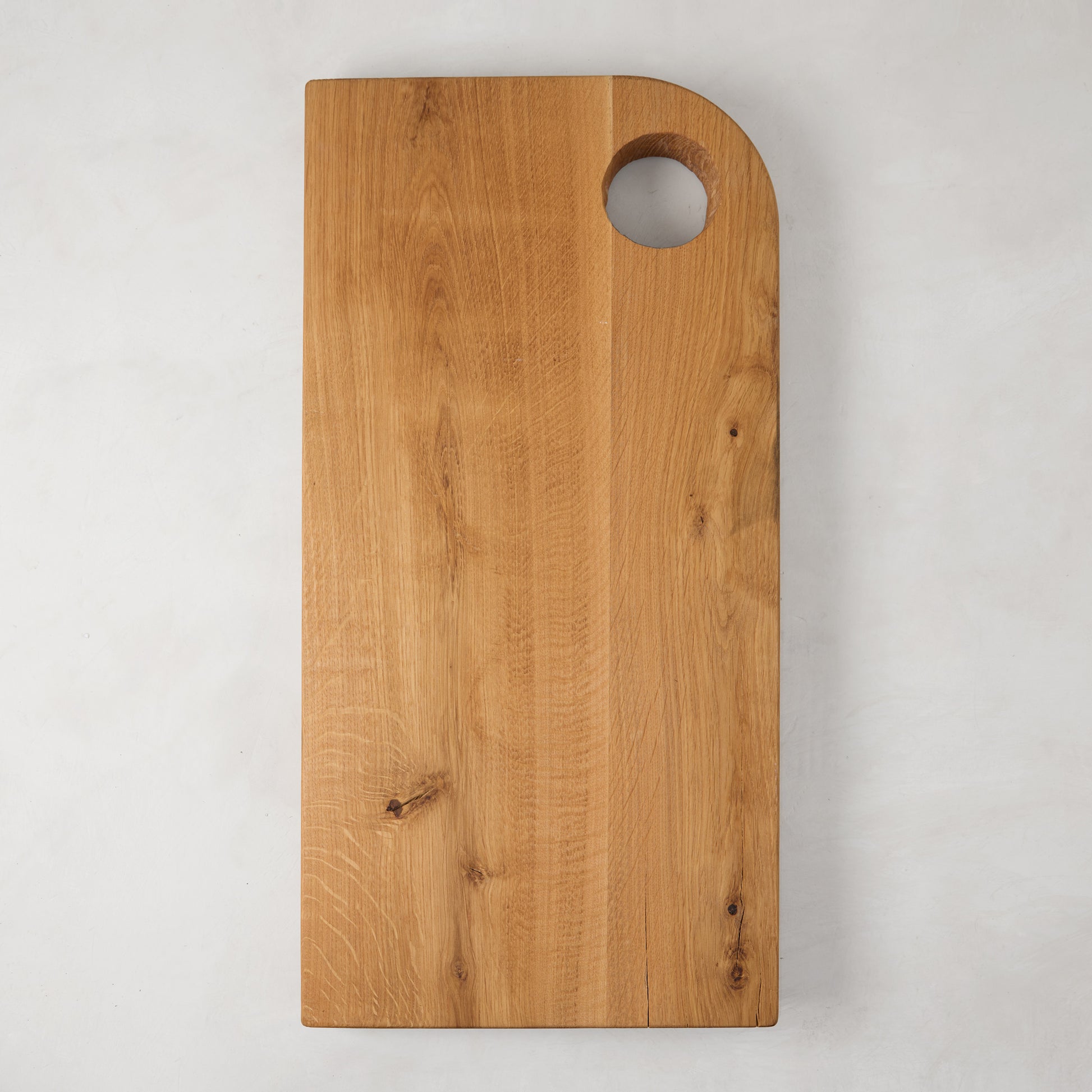 Large rectangular reclaimed oak barnwood serving board with a circular cutout handle.
