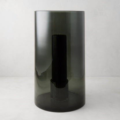 Large Diane Keaton + Hudson Grace smoke grey glass hurricane with dark pillar candle.
