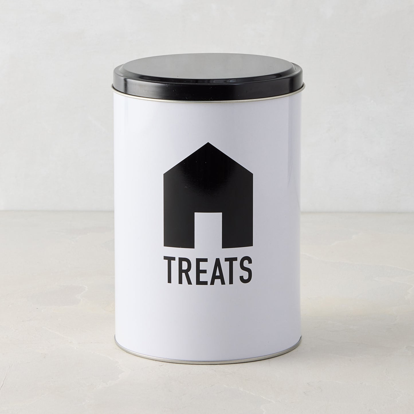 White metal Diane Keaton x Hudson Grace dog treat tin with black lid and DK House Icon.