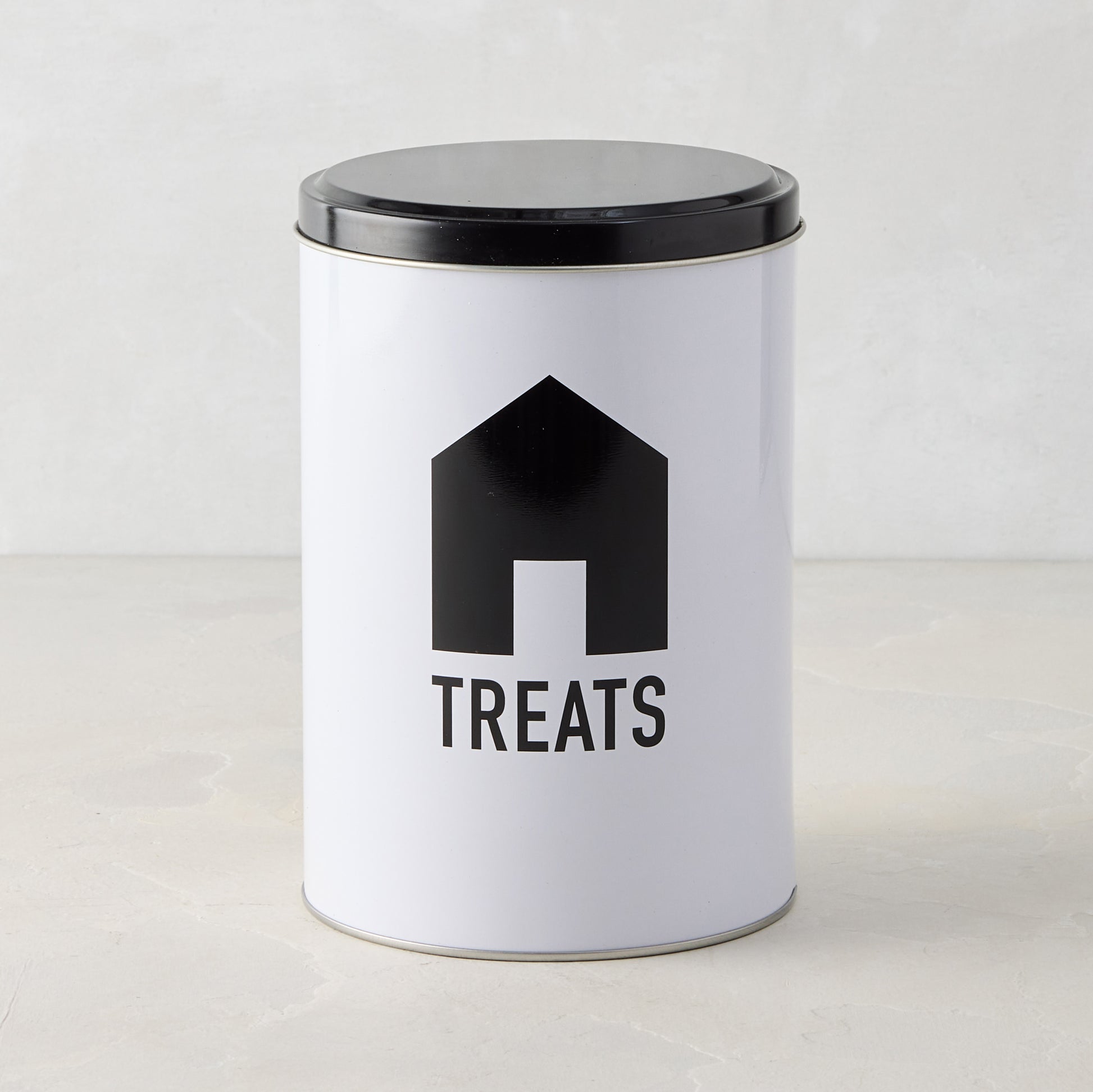White metal Diane Keaton x Hudson Grace dog treat tin with black lid and DK House Icon.