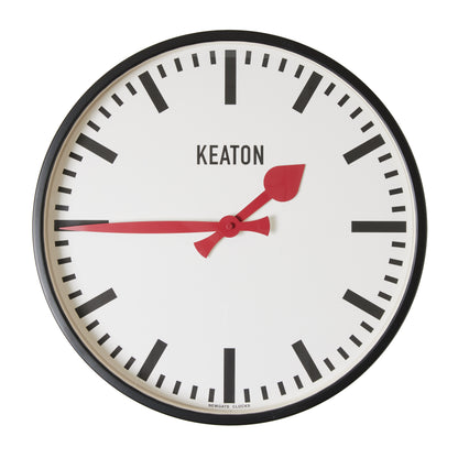 Diane Keaton x Hudson Grace Metro Wall Clock, black metal case, white dial, bold red hands.