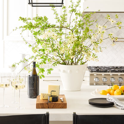 Diane Keaton + Hudson Grace Modern Dot Ceramic Centerpiece, white with polka dots, filled with green branches.