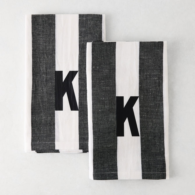 Set of 2 Diane Keaton + Hudson Grace monogrammed hand towels, grey and white striped, with black letter K.