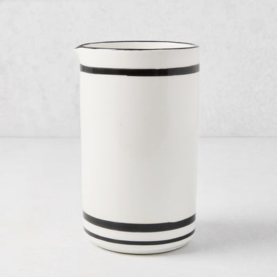 Diane Keaton + Hudson Grace white ceramic wine carafe with black stripes and rim.
