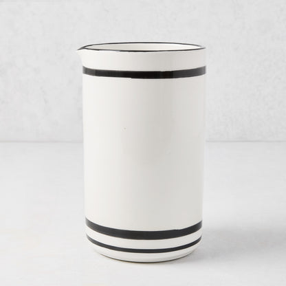 Diane Keaton + Hudson Grace white ceramic wine carafe with black stripes and rim.