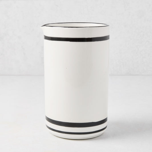 Diane Keaton + Hudson Grace white ceramic wine carafe with black stripes and rim.