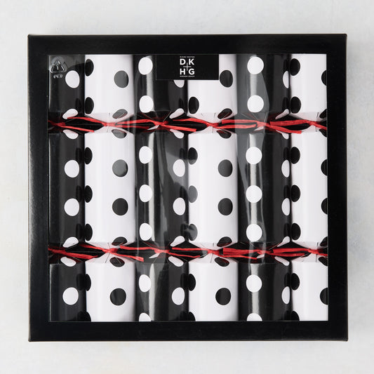 Diane Keaton + Hudson Grace polka dot Christmas crackers in black and white, tied with red string, in a black box.