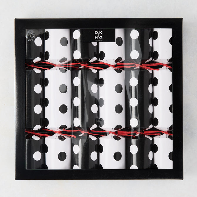 Diane Keaton + Hudson Grace polka dot Christmas crackers in black and white, tied with red string, in a black box.