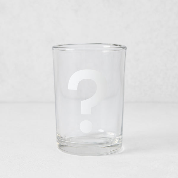 Clear glass everyday wine glass with a white question mark design.