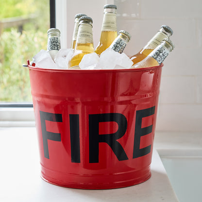 Diane Keaton x Hudson Grace red galvanized steel "FIRE" bucket with ice and bottled drinks.