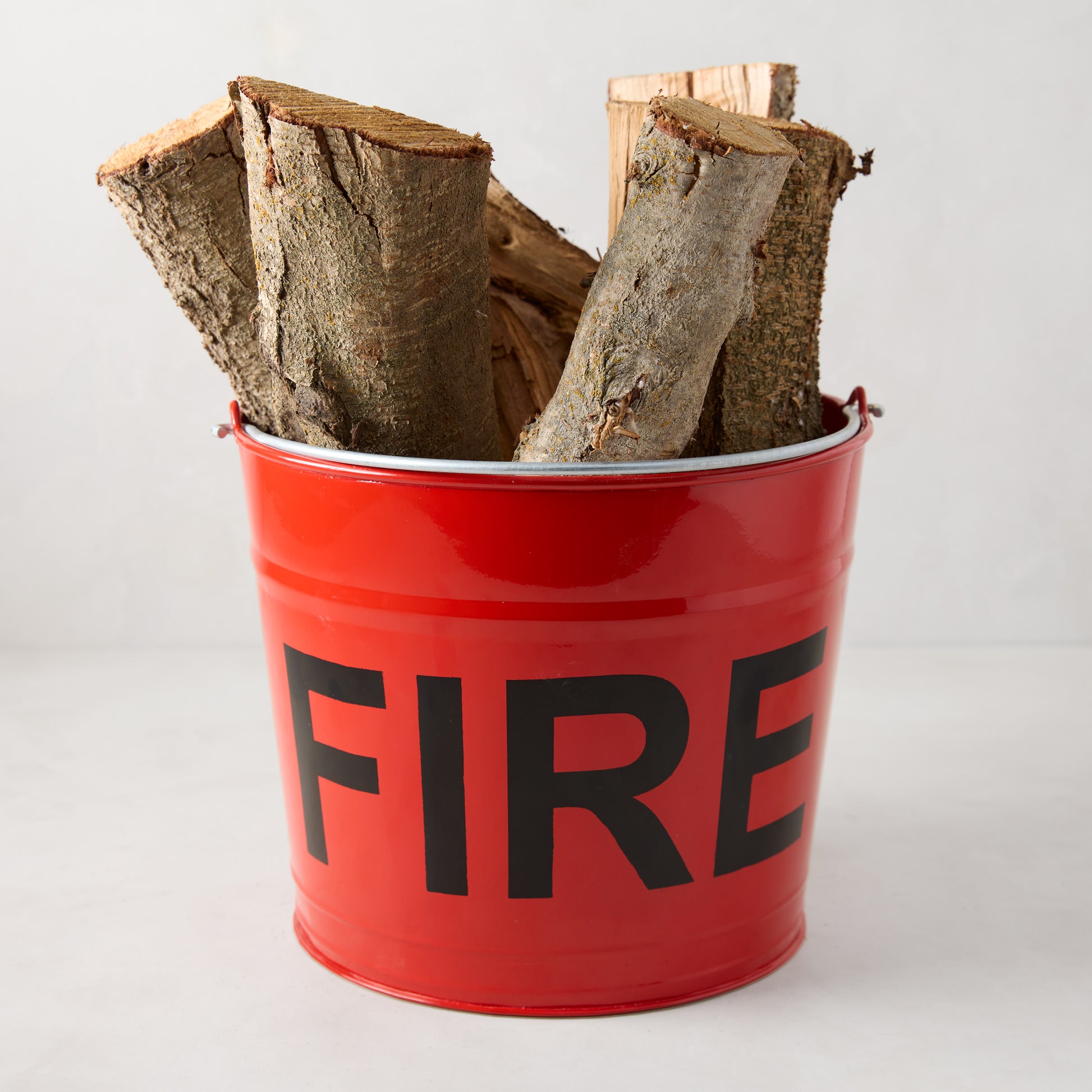 Diane Keaton + Hudson Grace Flame Red Galvanized Steel “Fire” Bucket with firewood.