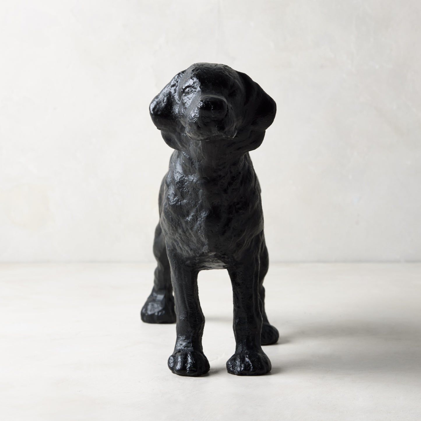 Matte black cast iron dog door stopper, "Reggie" design from Diane Keaton x Hudson Grace Collection.