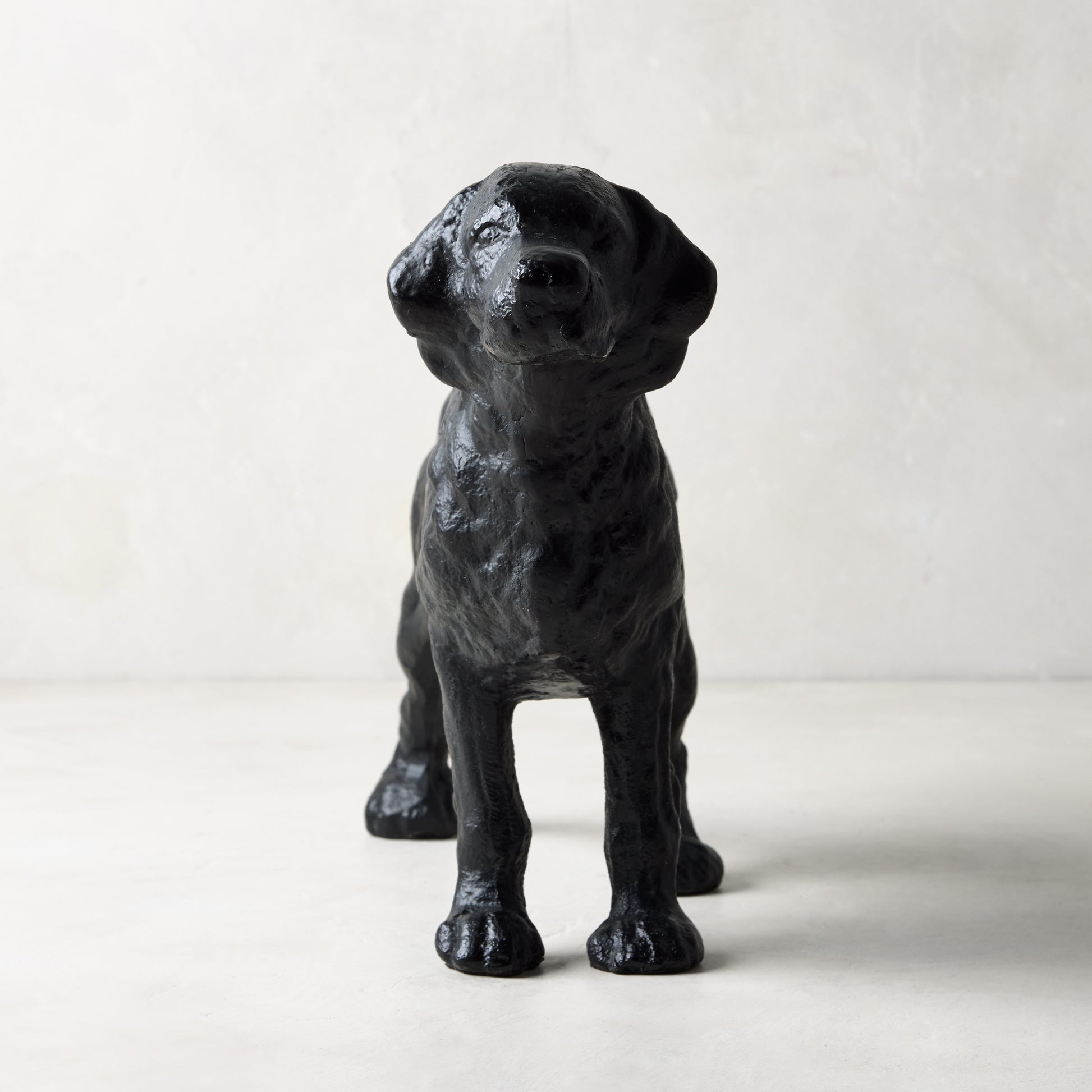Matte black cast iron dog door stopper, "Reggie" design from Diane Keaton x Hudson Grace Collection.
