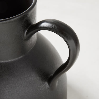 Diane Keaton + Hudson Grace sculptural black stoneware pitcher, close-up of handle.