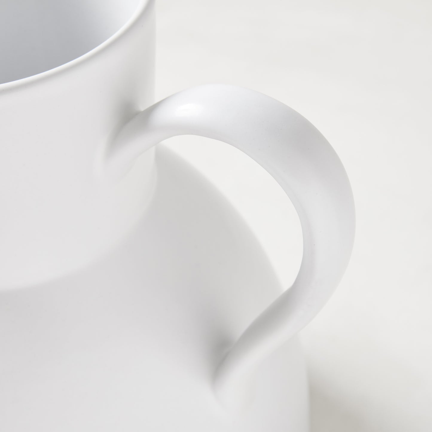 Diane Keaton + Hudson Grace sculptural white stoneware pitcher, close-up of handle.
