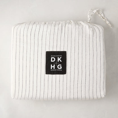 Diane Keaton + Hudson Grace Shirting Stripe Linen Duvet Cover, folded in its striped linen bag with logo.