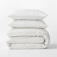 Diane Keaton + Hudson Grace Shirting Stripe Linen Duvet Cover set, folded, with two pillows.