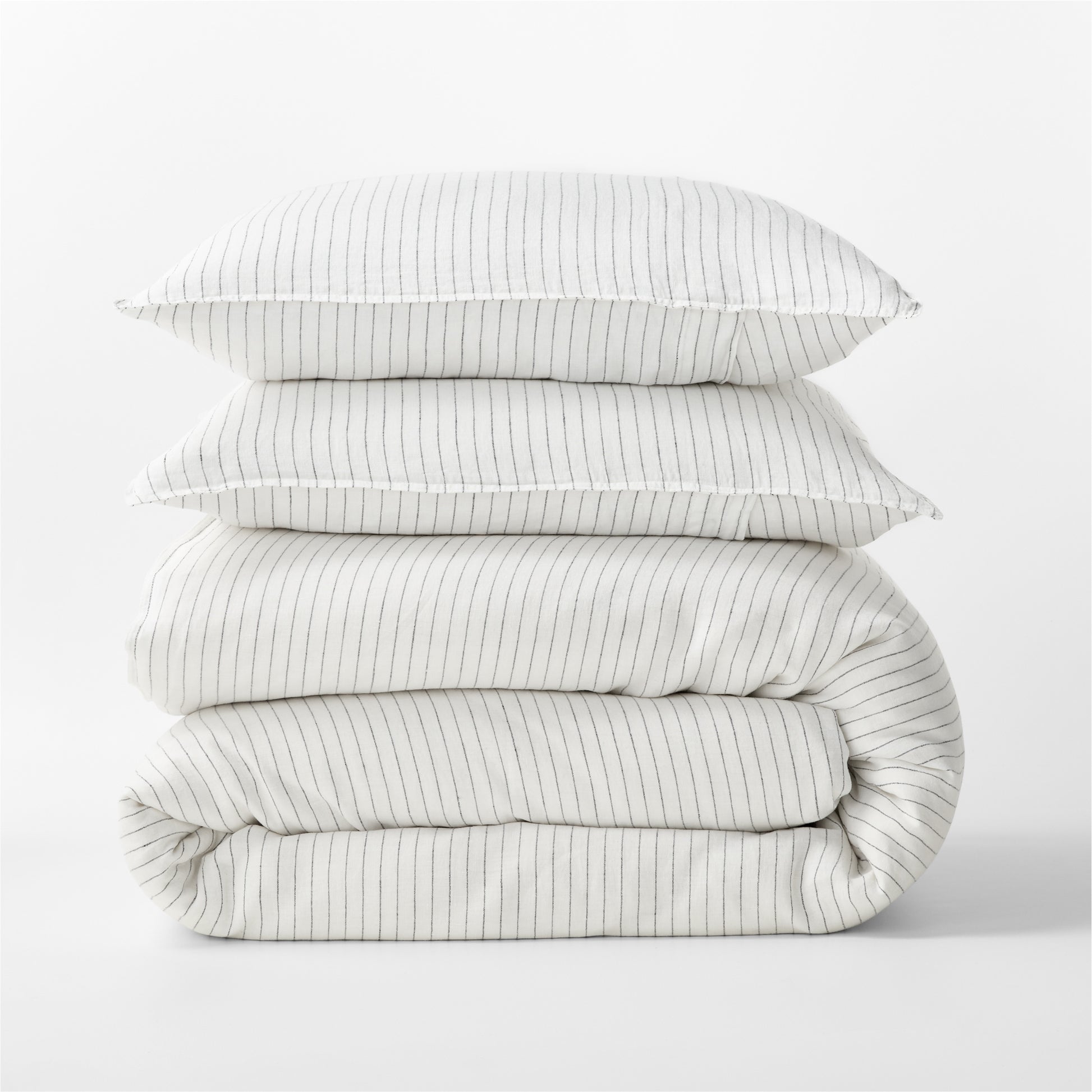 Diane Keaton + Hudson Grace Shirting Stripe Linen Duvet Cover set, folded, with two pillows.