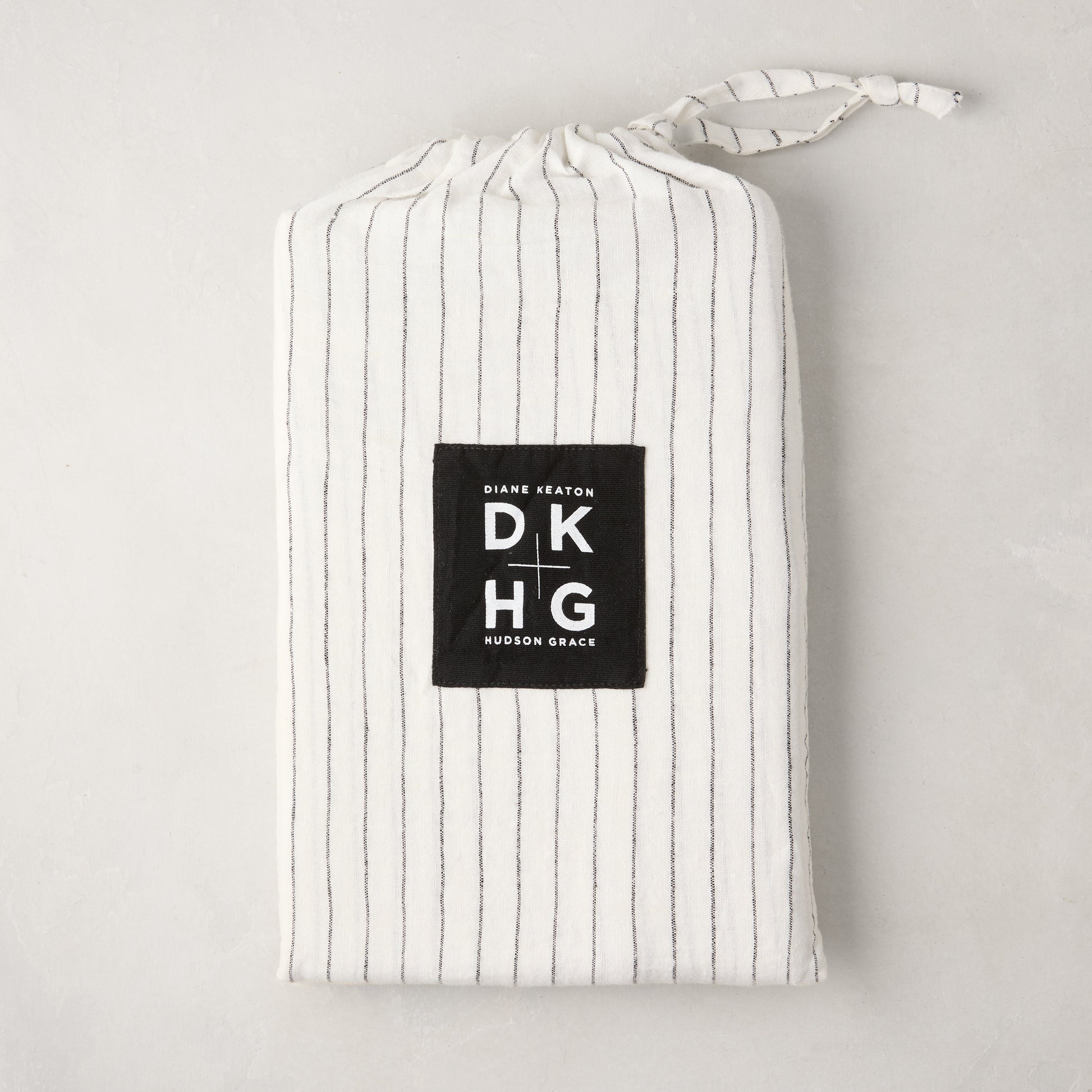 Diane Keaton x Hudson Grace Shirting Stripe Linen Shams, set of 2, in a white and black striped linen bag.