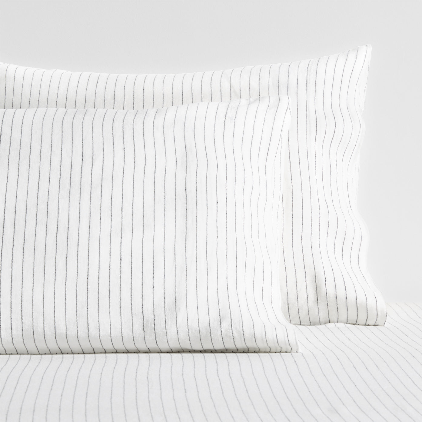 Diane Keaton + Hudson Grace white linen shams with thin black shirting stripes.