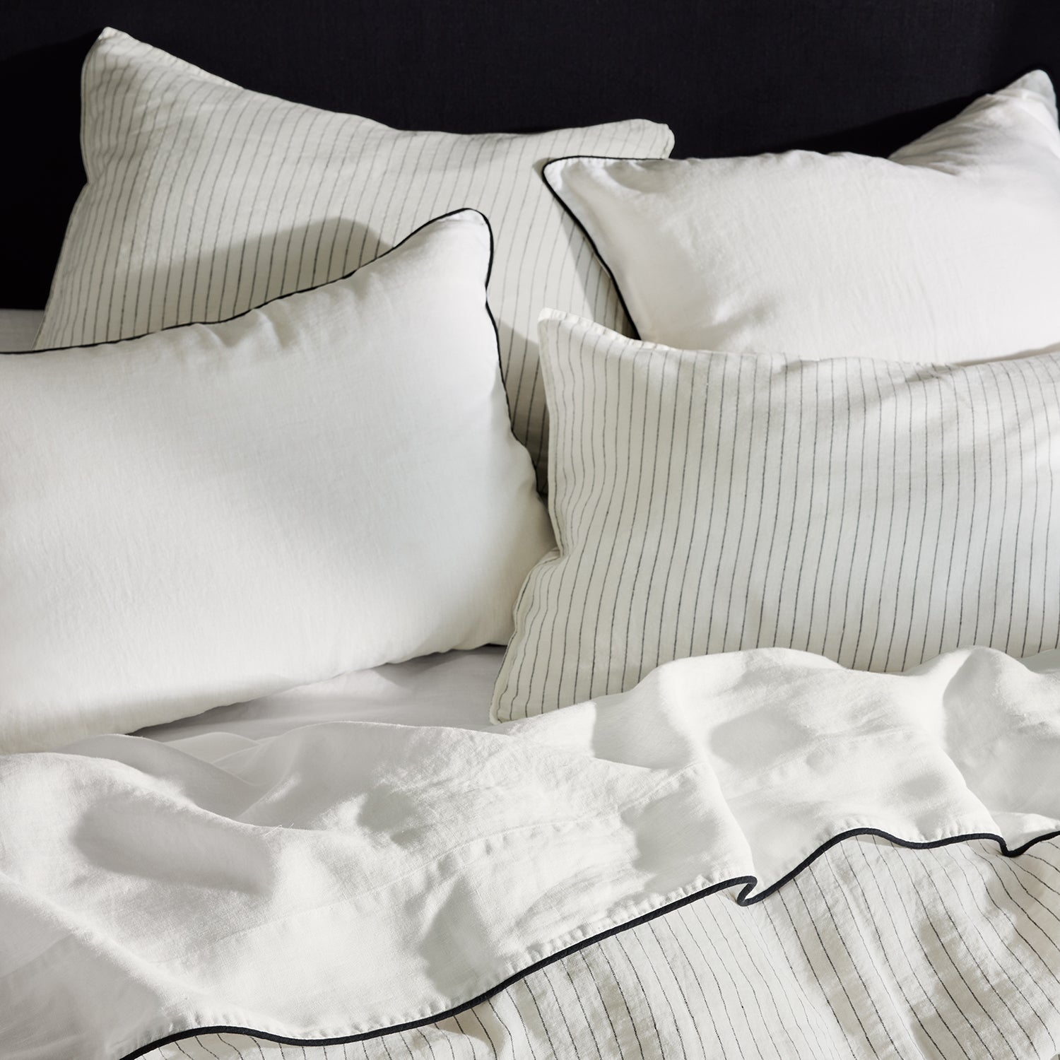 Diane Keaton x Hudson Grace Shirting Stripe Linen Sheet Set with white and black striped pillows and sheets.