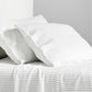 Diane Keaton x Hudson Grace Shirting Stripe Linen Sheet Set, white with thin black stripes.