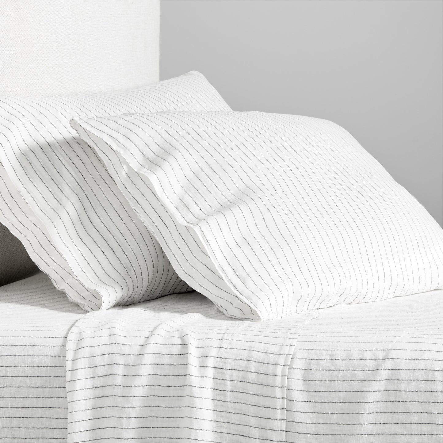 Diane Keaton x Hudson Grace Shirting Stripe Linen Sheet Set, white with thin black stripes.