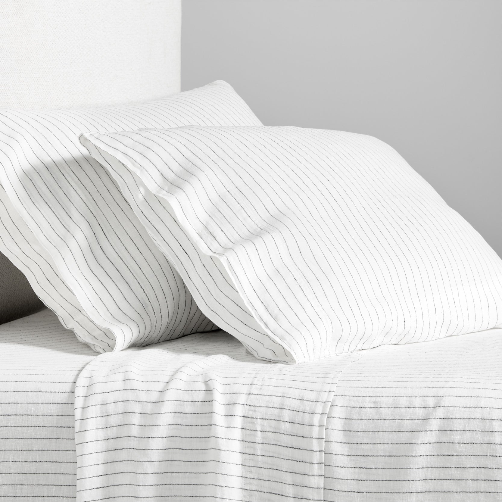 Diane Keaton x Hudson Grace Shirting Stripe Linen Sheet Set, white with thin black stripes.