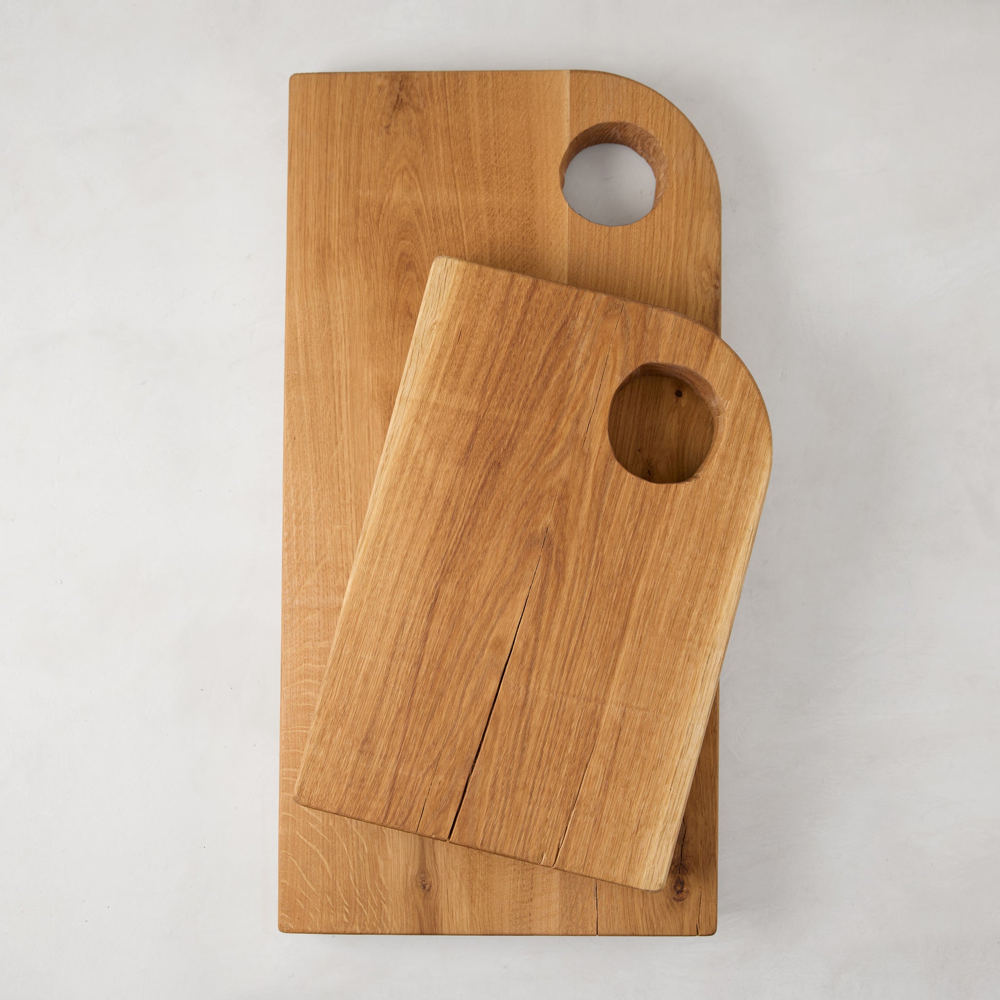 Diane Keaton + Hudson Grace small and large oak barnwood serving boards with circular cutout handles.