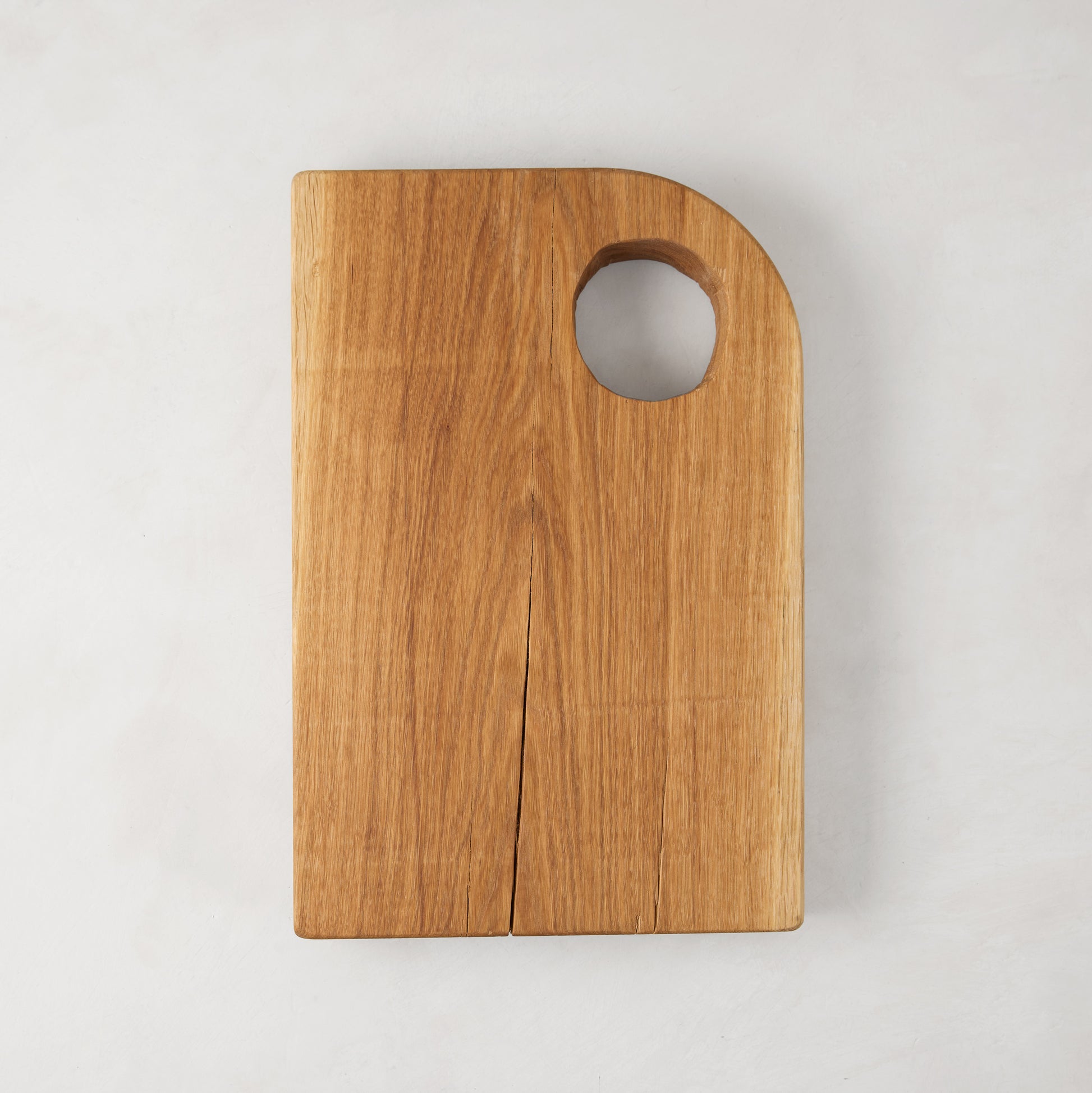 Small Diane Keaton + Hudson Grace oak barnwood serving board with a circular cutout handle.