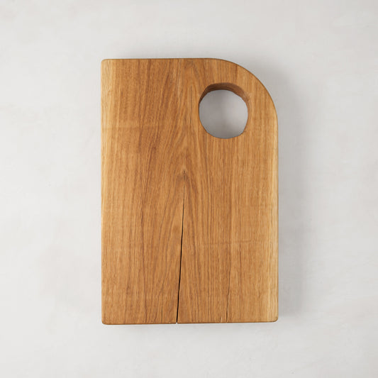 Small Diane Keaton + Hudson Grace oak barnwood serving board with a circular cutout handle.
