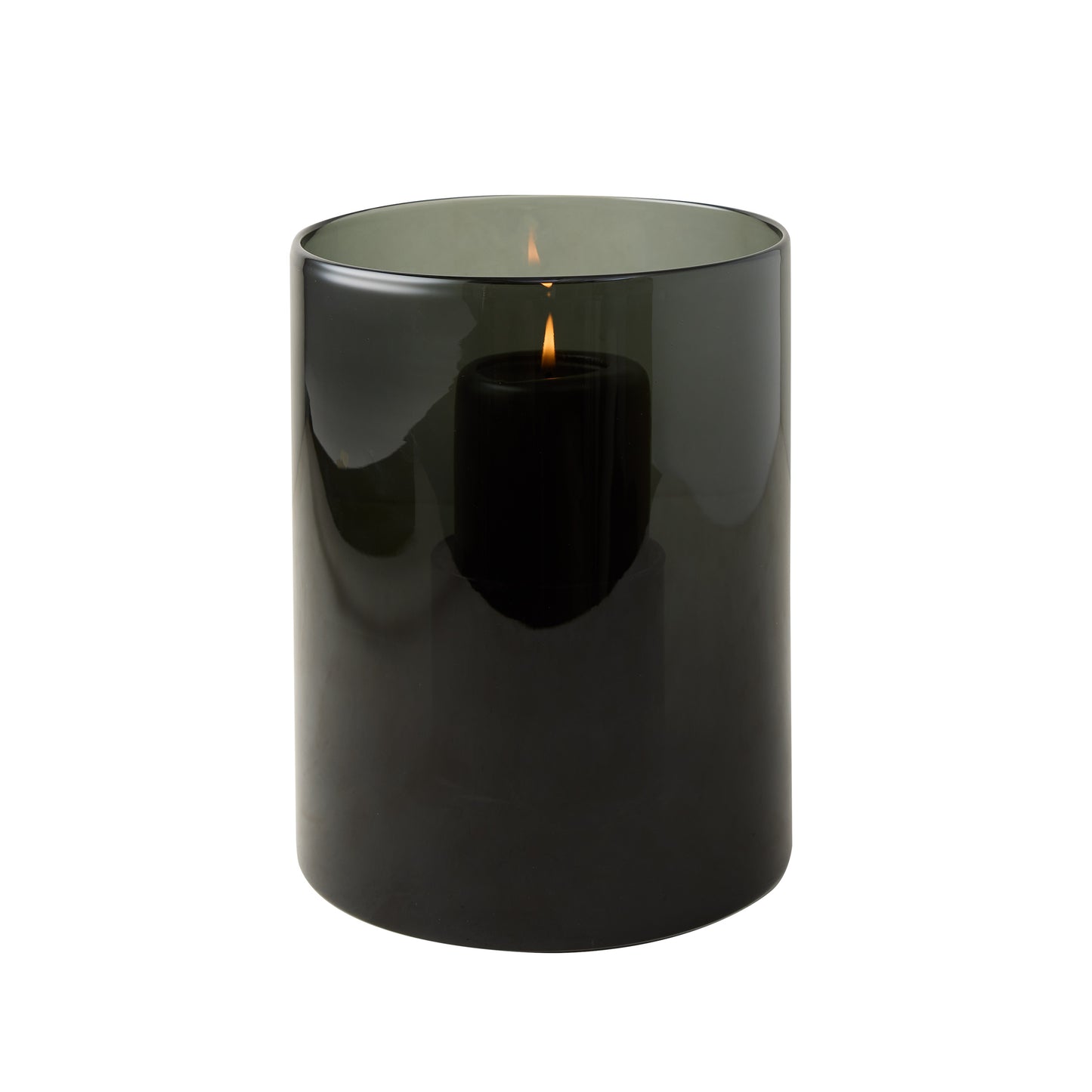 Small smoke grey hand-blown glass hurricane with a lit black pillar candle inside.