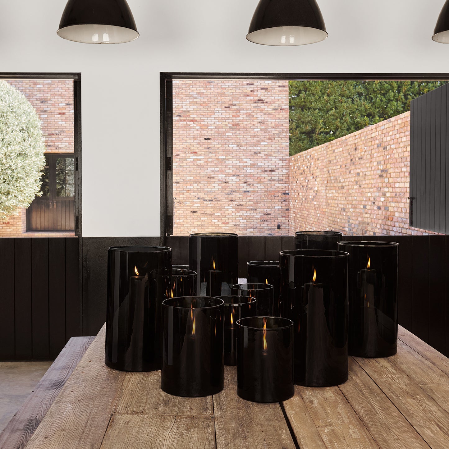 Diane Keaton + Hudson Grace large smoke grey glass hurricane with black pillar candles.