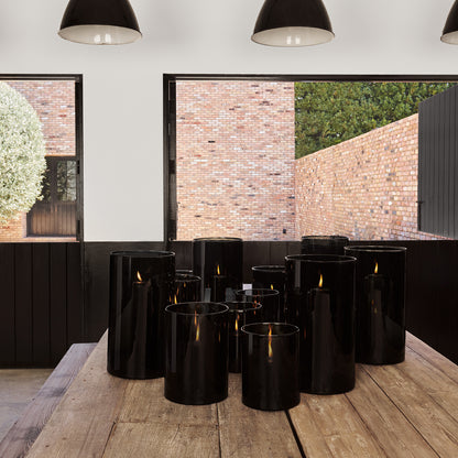 Diane Keaton + Hudson Grace large smoke grey glass hurricane with black pillar candles.