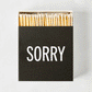 Diane Keaton + Hudson Grace "Sorry" boxed matches, black box with white text, natural wood matches.