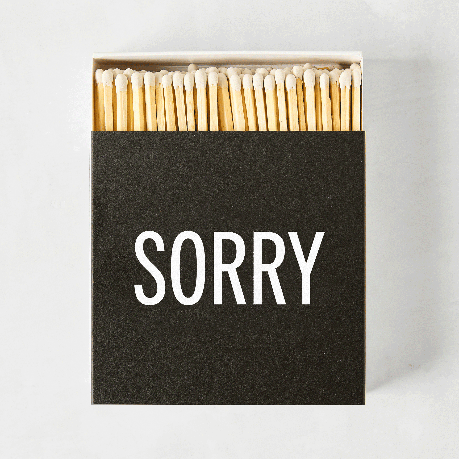 Diane Keaton + Hudson Grace "Sorry" boxed matches, black box with white text, natural wood matches.