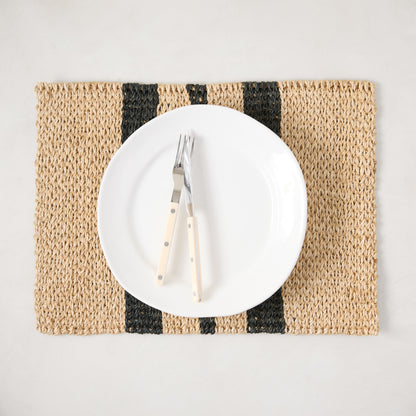 Diane Keaton + Hudson Grace tan and black stripe abaca woven placemat with white plate and forks.